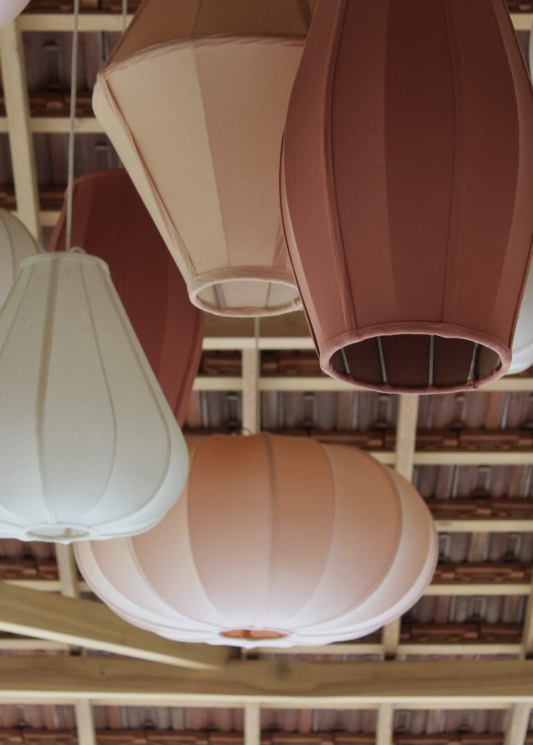 Pink and terracotta lanterns under the wooden roof